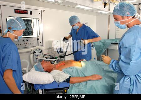 Doctors using a defibrillator to resuscitate a male heart attack victim Stock Photo