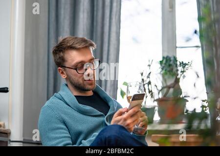 Man Calling His Friends From Kitchen And Drinking Wine With Them By Video Chat. Online Date, Online Meeting With Friends. Stay Home. Social Distance a Stock Photo
