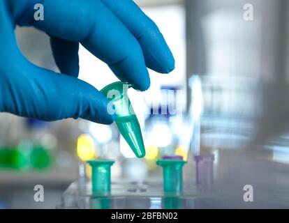 Scientist preparing a sample vial for automated analysis in the lab. Stock Photo