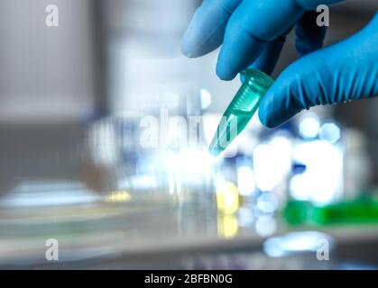 Scientist preparing a sample vial for automated analysis in the lab. Stock Photo