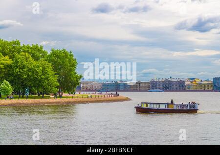 Cityscape of Saint Petersburg Leningrad city with row of old colorful buildings on embankment and boat ship on water of Neva river near Zayachy Hare I Stock Photo