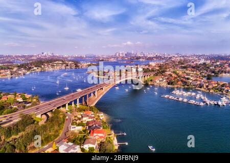 Gladesville bridge across Parramatta river in aerial view towards Sydney city CBD and harbour. Stock Photo
