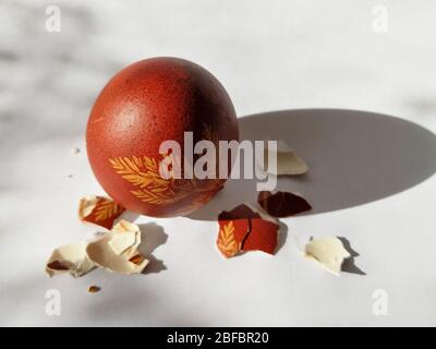 Broken eggshell painted Easter egg isolated on the white background Stock Photo