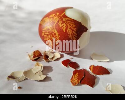 Broken eggshell painted Easter egg isolated on the white background Stock Photo