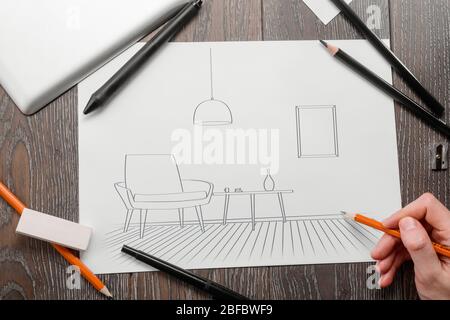 Man drawing a living room sketch, making an interior project Stock Photo