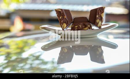Chocolate bars containing nuts on a plate Stock Photo