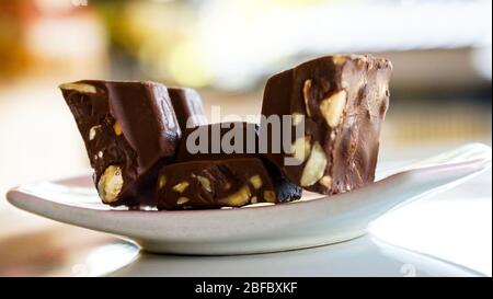 Chocolate bars containing nuts on a plate Stock Photo