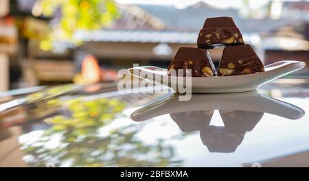 Chocolate bars containing nuts on a plate Stock Photo