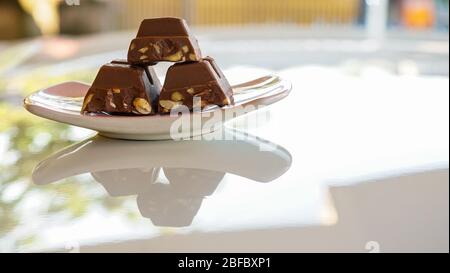 Chocolate bars containing nuts on a plate Stock Photo