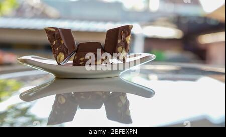 Chocolate bars containing nuts on a plate Stock Photo