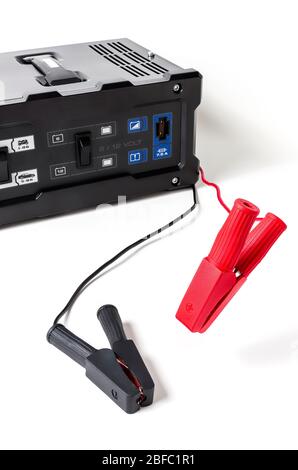 vertical view in foreground of a car battery charger with jumper cable isolated on white background Stock Photo