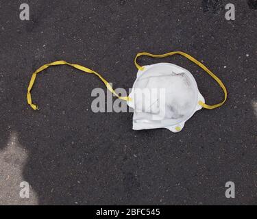 face mask discarded in a parking lot during Covid-19 virus pandemic, California Stock Photo