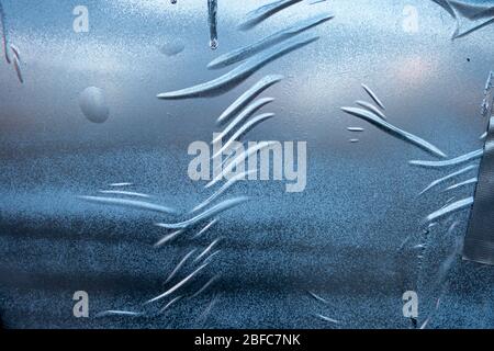 uneven crinkly gued silver blue spray painted wall paper poster effect Stock Photo
