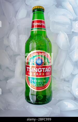 Calgary, Alberta, Canada. April 17, 2020. A Tsingtao Beer bottle on a bed of ice. Stock Photo