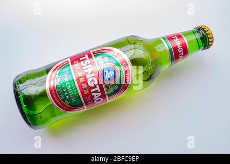 Calgary, Alberta, Canada. April 17, 2020. A Tsingtao Beer bottle on a white background Stock Photo