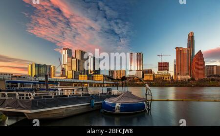 Panorama with downtown high-rises reflecting sunset golden hour light viewed across Lady Bird Lake or Town Lake on Colorado River in Austin, Texas USA Stock Photo