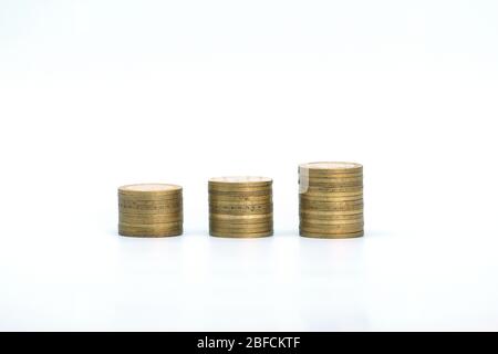 Piles of golden metallic coins. Columns of coins of different heights. The concept of business, economy, finance, investment and prices. Place for text and background for design. Stock Photo