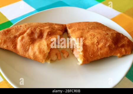 Plate of Empanada de Camarones or Shrimps and Cheese Filled Pastry Cut in Half
