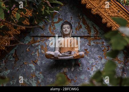 Cinematic photo of an old buddha sculpture in khmer style on an abandoned temple in Bokor Mountains in Kampot Province, Cambodia Stock Photo