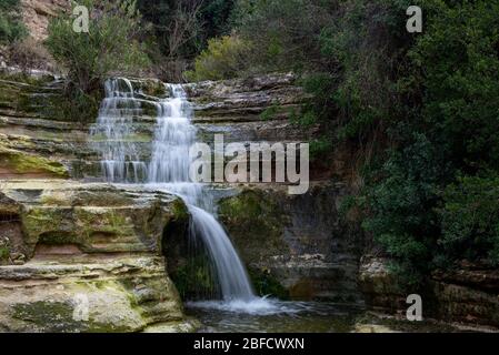 Beautiful waterfall splashing in the canyon creating a small lake at Troodos mountains in Cyprus Stock Photo