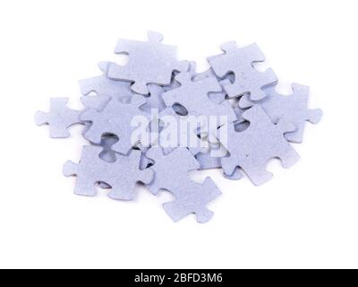 Heap of puzzles pieces isolated on white background Stock Photo