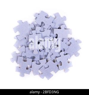 Heap of puzzles pieces isolated on white background Stock Photo