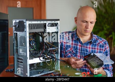 Computer repair. Computer technician working on a personal computer. Stock Photo