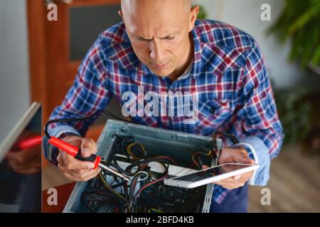 Computer repair. Computer technician working on a personal computer. Stock Photo
