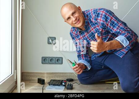 Man installing light switch after home renovation Stock Photo
