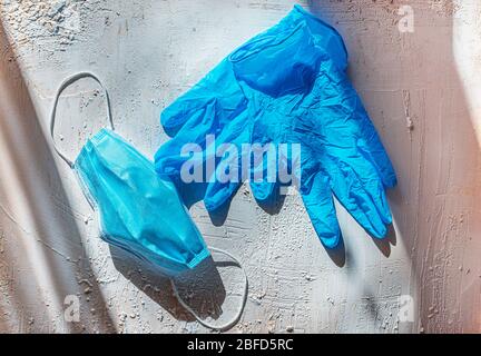 Worn protective masks and rubber gloves. Rubbish after coronavirus. Protection against Covid-19. Environment and the virus. Spring 2020. Fighting the Stock Photo