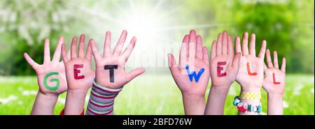 Children Hands Building Word Get Well, Grass Meadow Stock Photo
