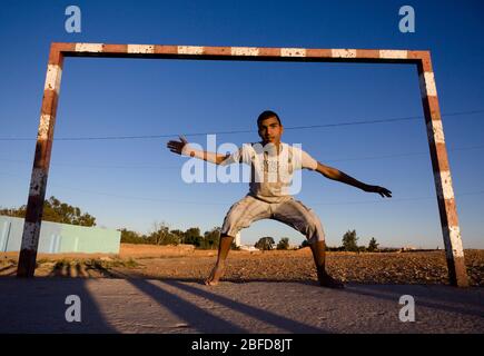 Moroccan boy playing goalkeeper in the Western Sahara, Morocco Stock ...