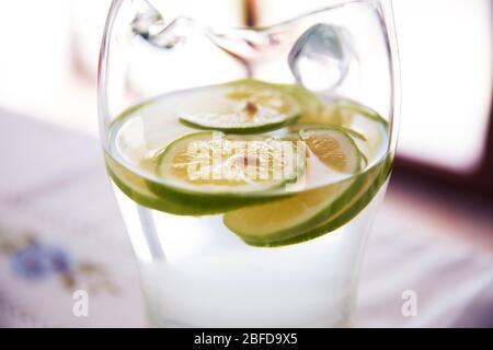 Mineral infused water with limes, lemons . Citrus lemonade in glass jur. Lemon in a glass jar . Stock Photo