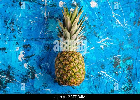 Fresh sweet pineapple on blue textured background, top view copy space Stock Photo