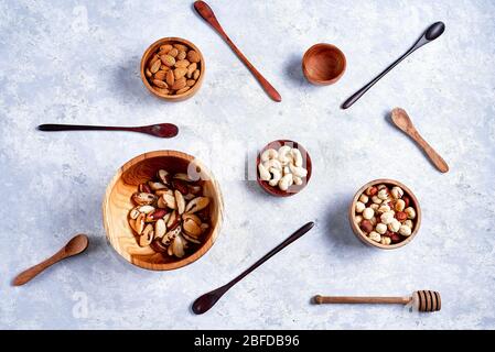 a variety of nuts in wooden bowls pattern Stock Photo