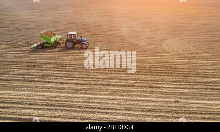 Planting of potatoes. Soil preparation, mound confection. Sowing with a potato planter. Stock Photo