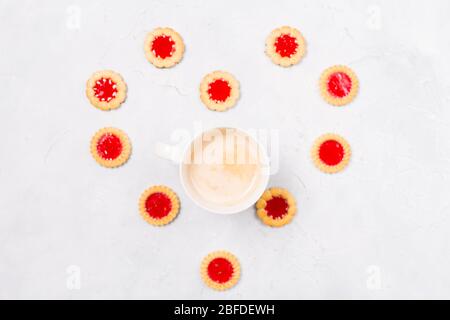 Heart frame made from cookies with coffee cup inside on white background. Space for text. Sweet life greeting. Copy space. Flat lay. Top view.  Stock Photo