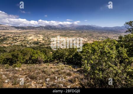 Top view of the Lassithi Plateau on a sunny clear day with a cloudy sky in the background. Crete island, Greece. Stock Photo