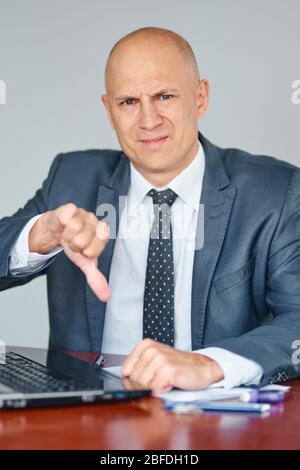 Man having stressful time working on laptop. Business problems concept Stock Photo