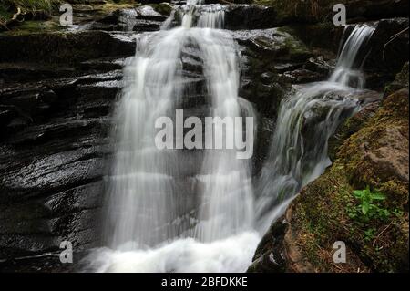 Small waterfall at the confluence of Nant Bwrefwr and its last tribuary stream. Stock Photo