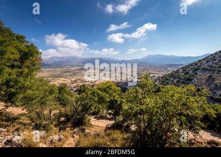 Top view of the Lassithi Plateau on a sunny clear day with a cloudy sky in the background. Crete island, Greece. Stock Photo