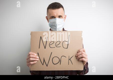 Need work, the inscription in the hands of the employee. The concept of unemployment, crisis. Need a job. Stock Photo
