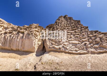 Canyon mountains on Vlychada beach on a sunny summer day. Santorini island, Greece. Stock Photo