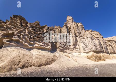 Canyon mountains on Vlychada beach on a sunny summer day. Santorini island, Greece. Stock Photo