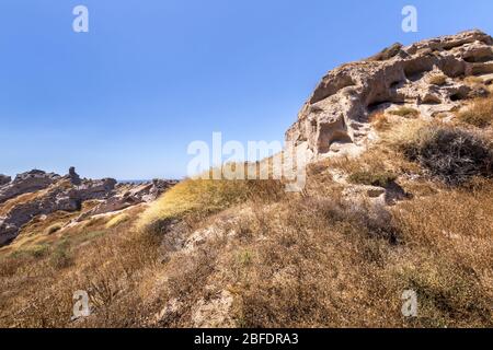 Canyon mountains on Vlychada beach on a sunny summer day. Santorini island, Greece. Stock Photo