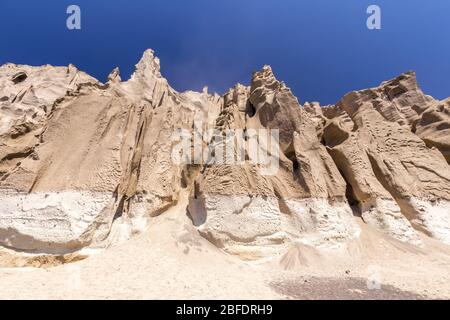 Canyon mountains on Vlychada beach on a sunny summer day. Santorini island, Greece. Stock Photo