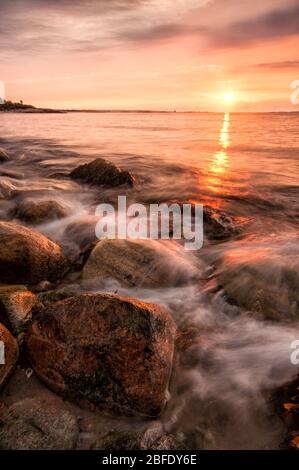 Dawn breaks over the wave-kissed shores of Long Island Sound (Harkness Memorial State Park, Waterford, Connecticut). Stock Photo