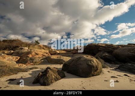 Clouds drift over the rocky sands of coastal Connecticut (Harkness Memorial State Park, Waterford, Connecticut). Stock Photo