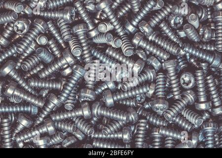 A huge arrenge of taping metal or iron screws, screws background, wallpaper, texture, industrial background and concept Stock Photo