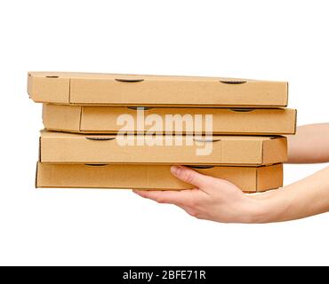 Female hands holding pizza boxes. Isolated on white. Food order and delivering concept. Stock Photo